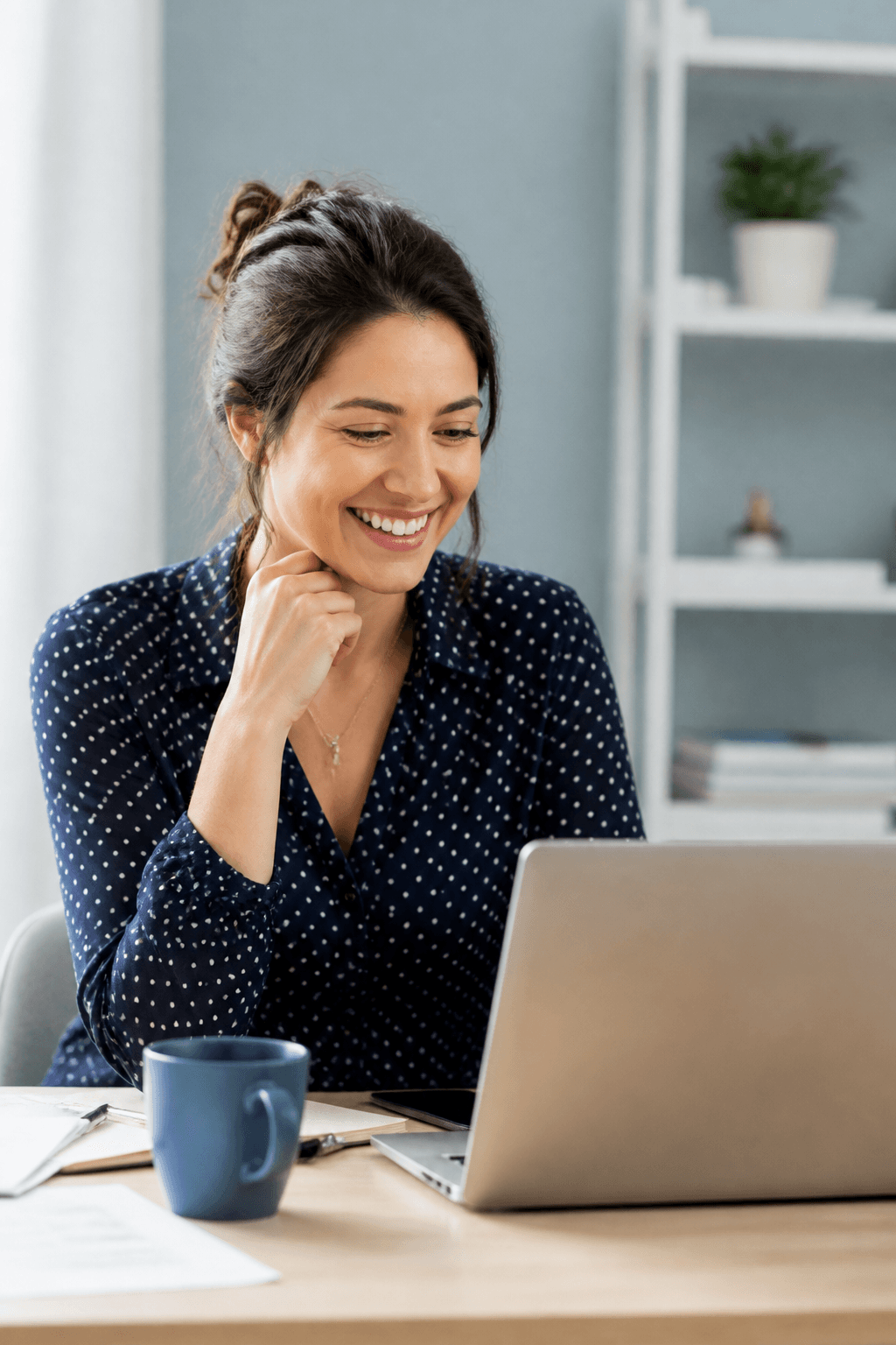 A happy person reviewing offers on a laptop